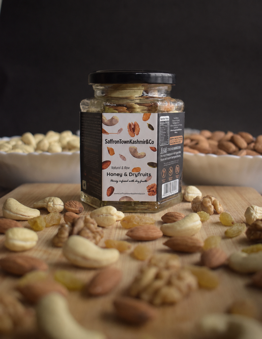 Mixed nuts and dry fruits in honey close-up